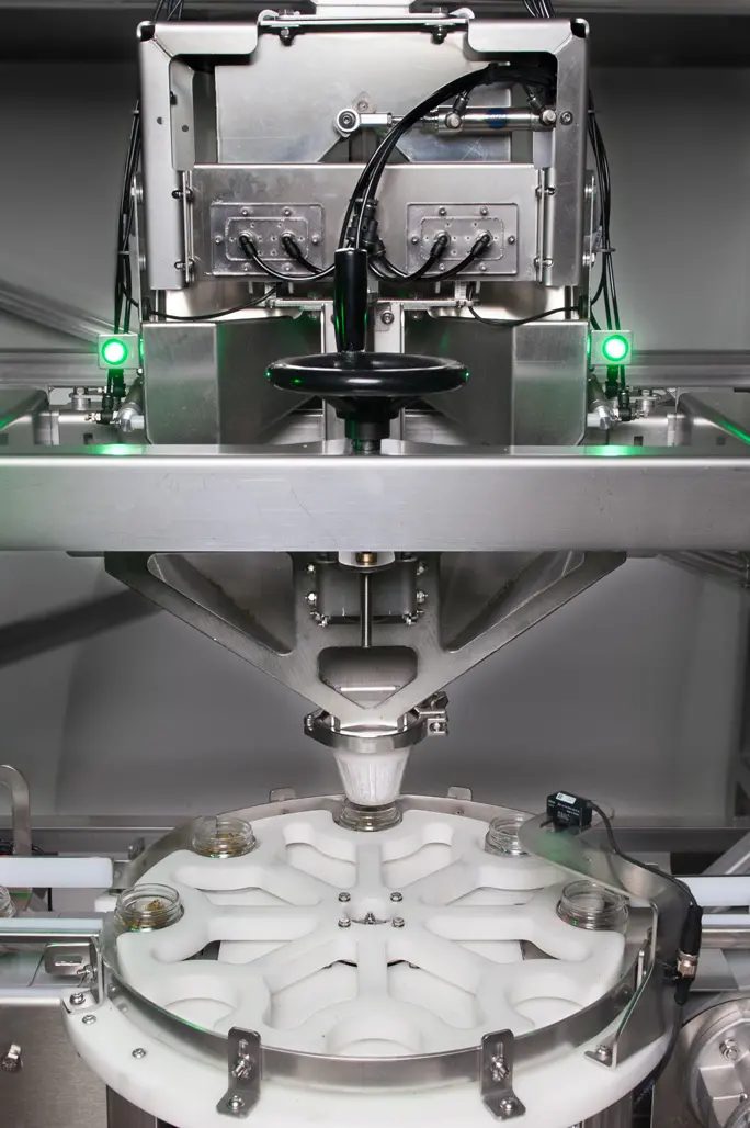 Green Vault Systems jar filling station with checkweigher